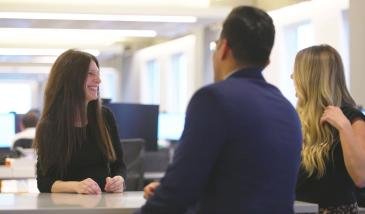 Employees chatting at a table